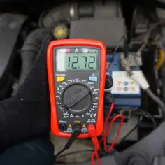 Multimetr pokazuje 12.72V. Sprawdzamy, ile volt powinien ładować alternator, by akumulator był w pełni sprawny.