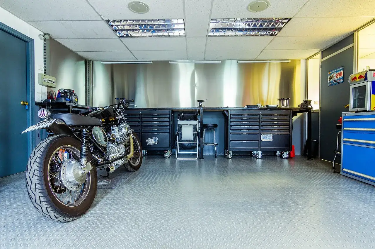 Warsztat z motocyklem. Pamiętaj o regularnej wymianie oleju w motocyklu, co ile km wymiana oleju w motocyklu zależy od modelu.
